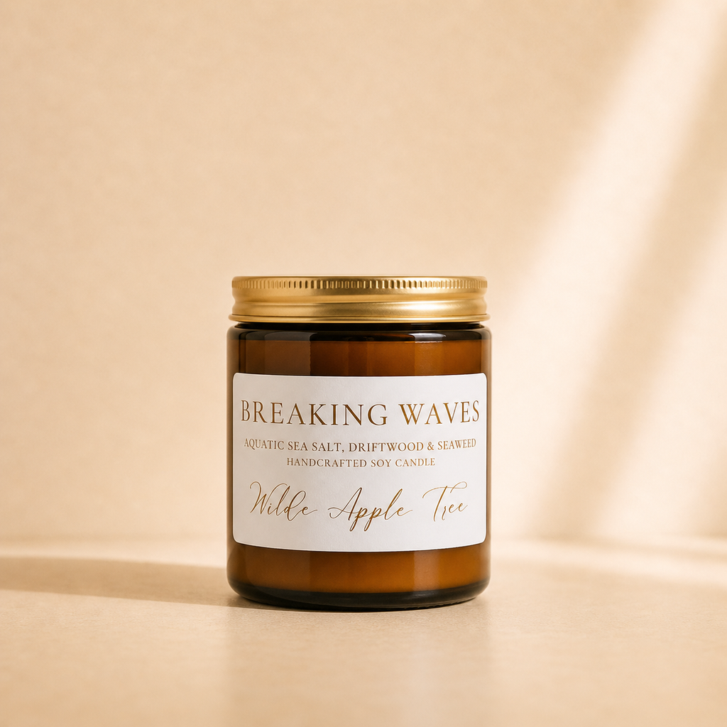 Wilde Apple Tree Breaking Waves medium soy candle in amber glass jar with gold lid in warm studio light, aquatic sea salt driftwood and seaweed handcrafted soy candle made in Australia
