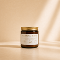 Wilde Apple Tree Breaking Waves mini soy candle in amber glass jar with gold lid, warm studio lighting with soft shadows, aquatic sea salt driftwood and seaweed scented handcrafted soy candle made in Australia