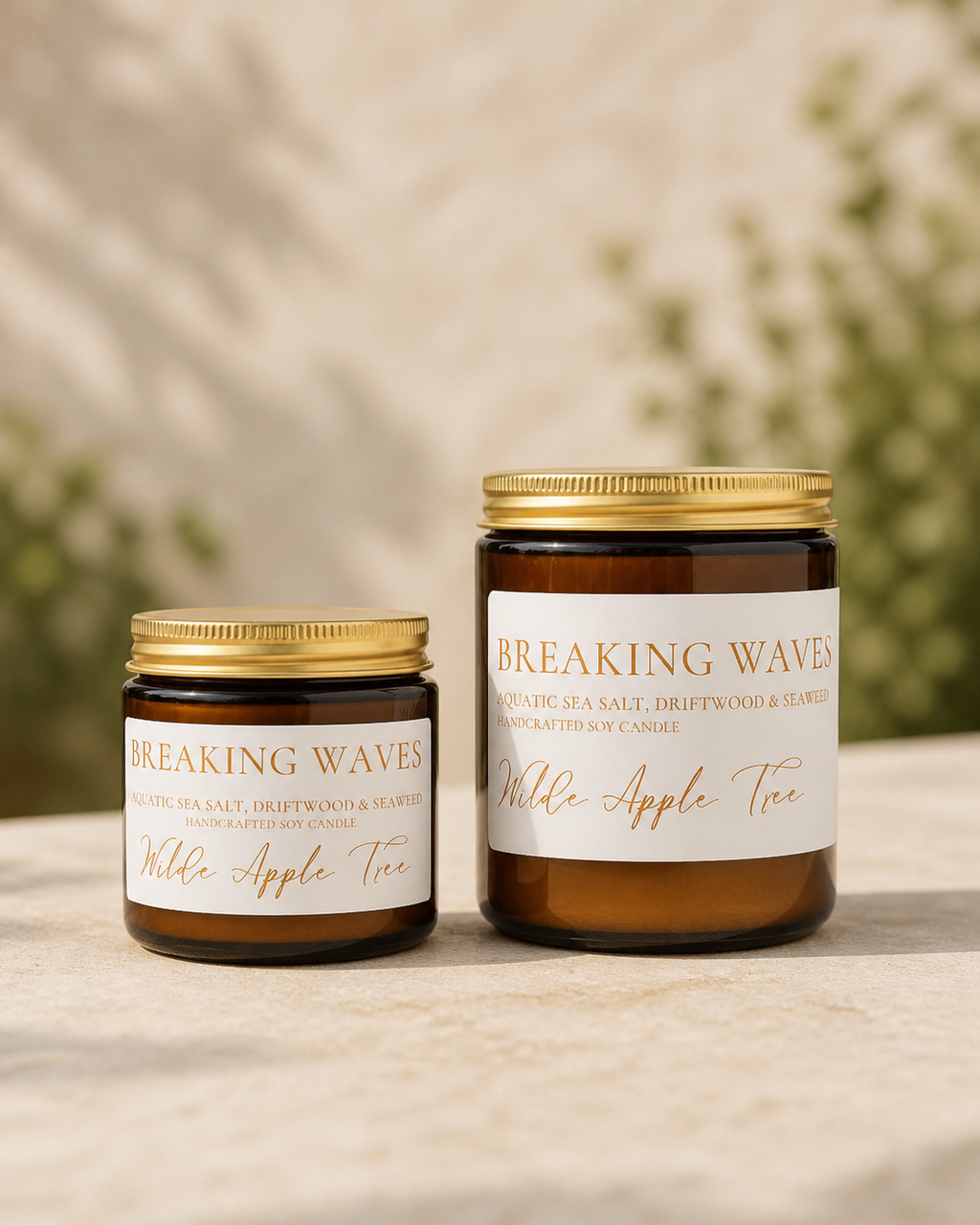 Wilde Apple Tree Breaking Waves handcrafted soy candles in mini and medium amber glass jars side by side in natural light, aquatic sea salt driftwood and seaweed scent, made in Australia