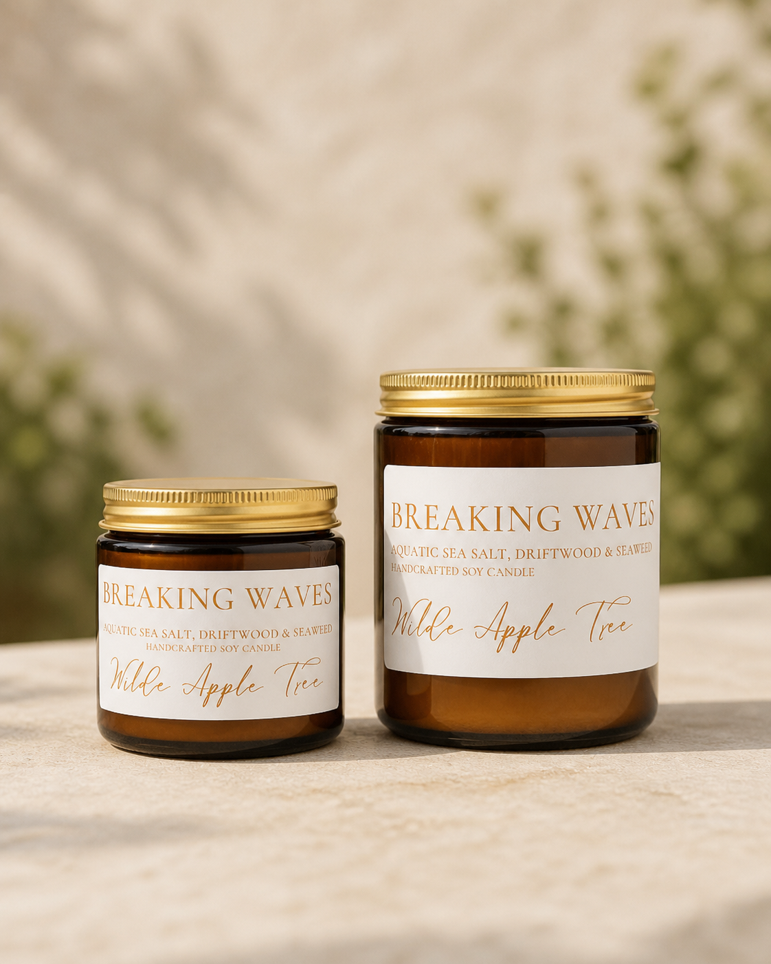 Wilde Apple Tree Breaking Waves handcrafted soy candles in mini and medium amber glass jars side by side in natural light, aquatic sea salt driftwood and seaweed scent, made in Australia