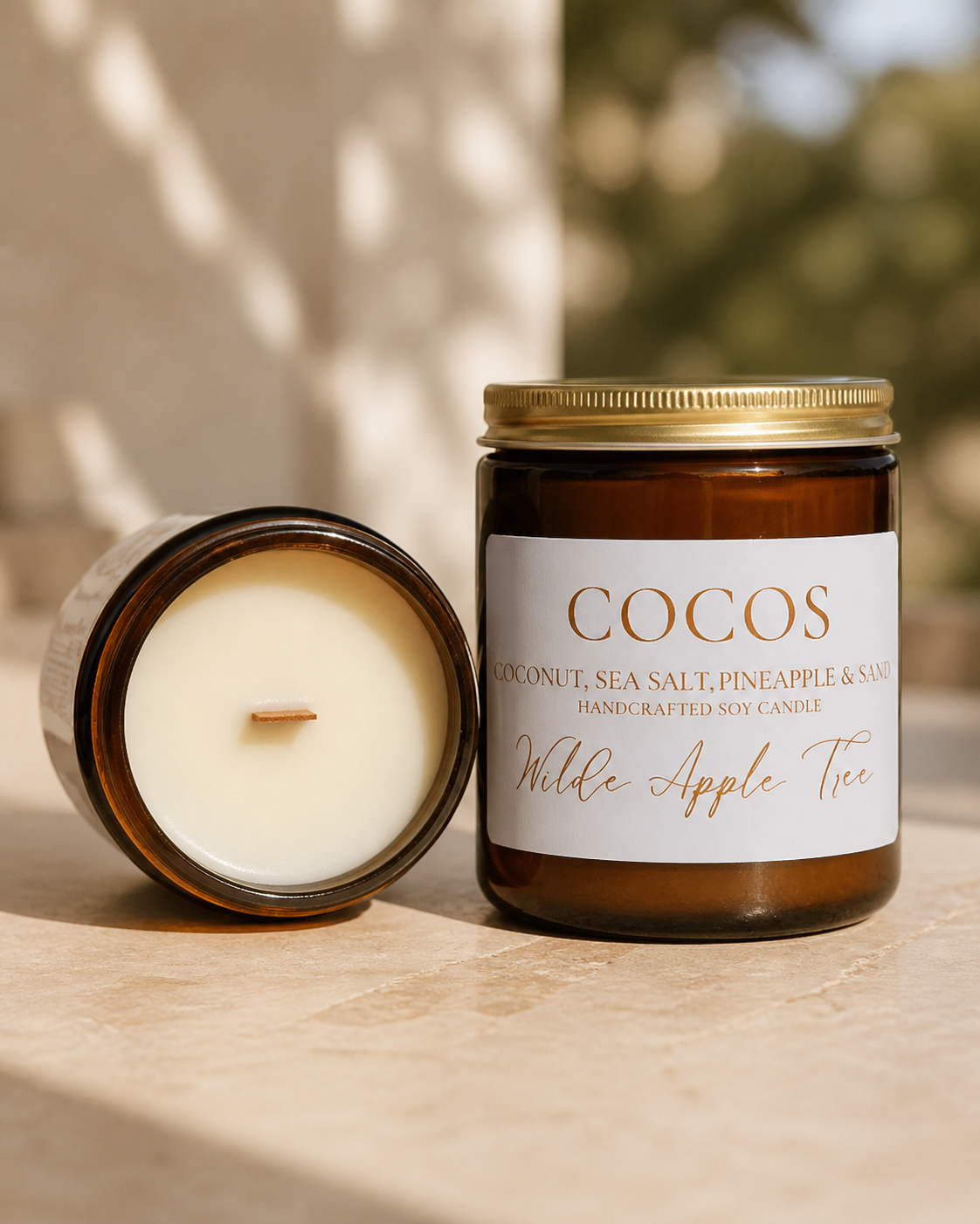 Wilde Apple Tree Cocos medium soy candle in amber glass jar with lid removed revealing natural wooden wick, coconut sea salt and pineapple scent, handcrafted in Australia