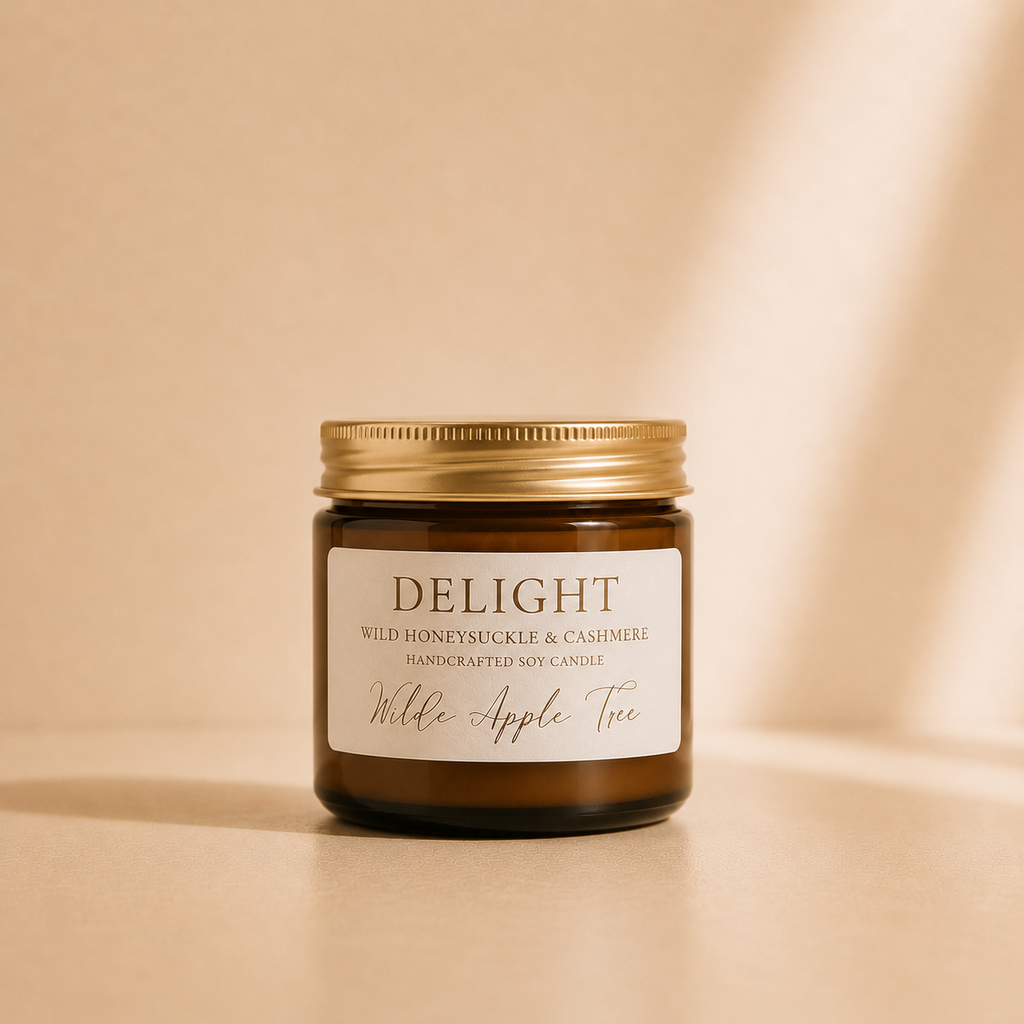 Wilde Apple Tree Delight mini soy candle in amber glass jar with gold lid, photographed in warm studio light, wild honeysuckle and cashmere handcrafted soy candle made in Australia