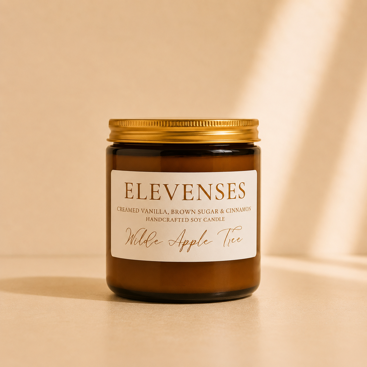 Wilde Apple Tree Elevenses medium soy candle in amber glass jar showing natural wooden wick, scented with creamed vanilla, brown sugar and cinnamon, hand-poured in Australia