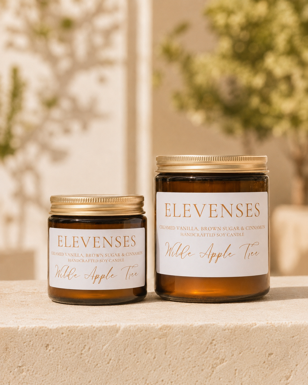 Wilde Apple Tree Elevenses handcrafted soy candles in mini and medium amber glass jars side by side, creamed vanilla, brown sugar and cinnamon scent, made in Australia