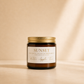 Wilde Apple Tree Sunset mini soy candle in amber glass jar with gold lid, warm studio lighting with soft shadows, margarita coconut and sweet hibiscus scented handcrafted soy candle made in Australia